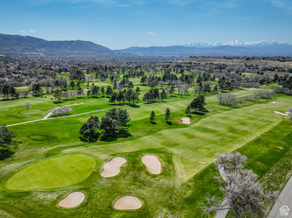 Bird's eye view of a mountainous background and a golf course