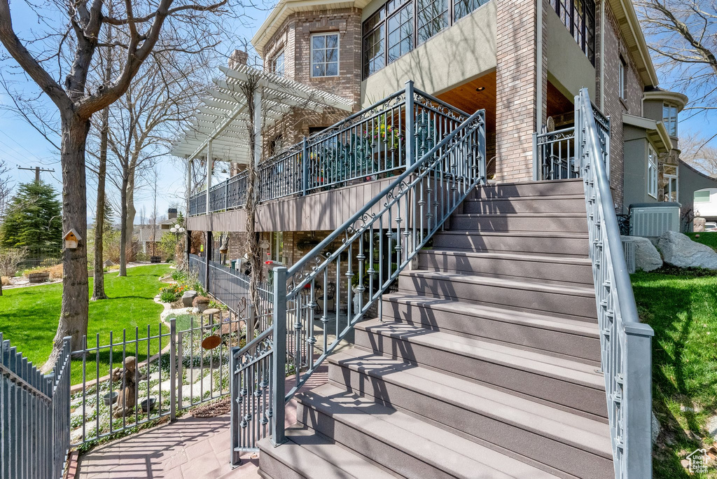 Exterior space with stairs and a pergola