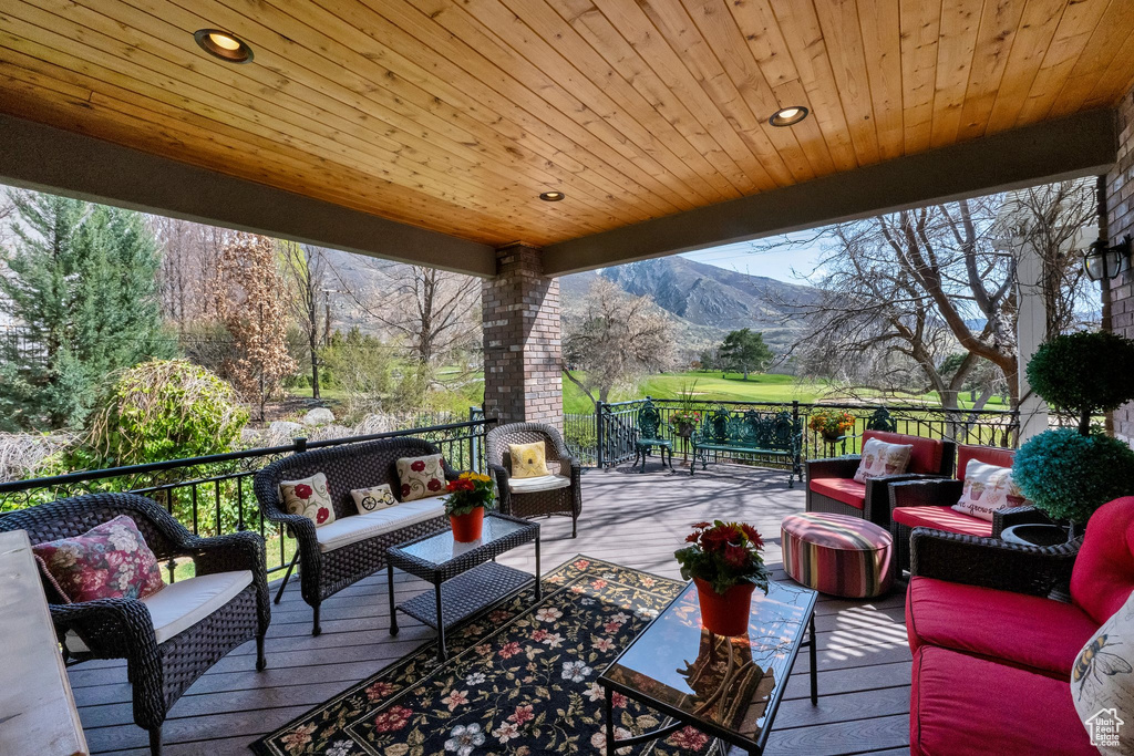 Deck featuring an outdoor living space and a mountain view