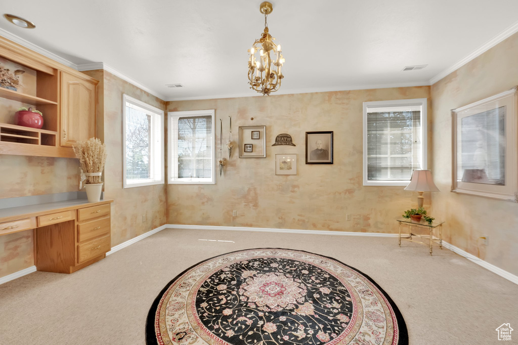 Office area featuring light carpet, built in desk, a chandelier, and crown molding