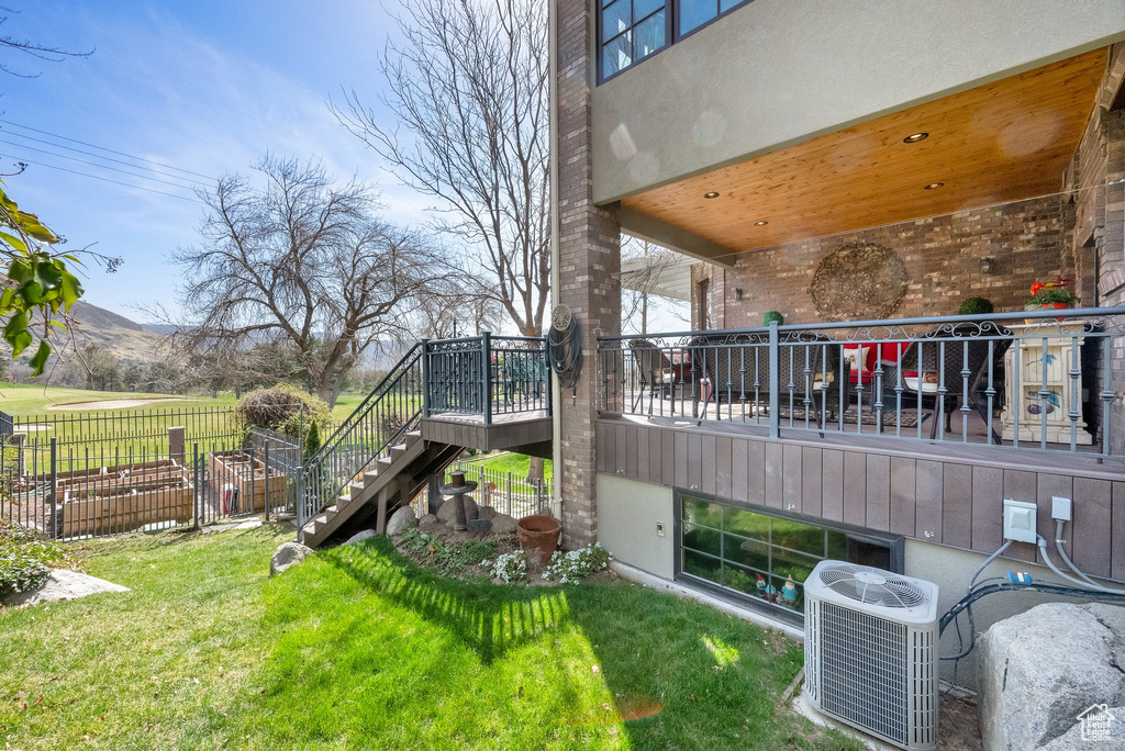 View of yard featuring stairs and a wooden deck