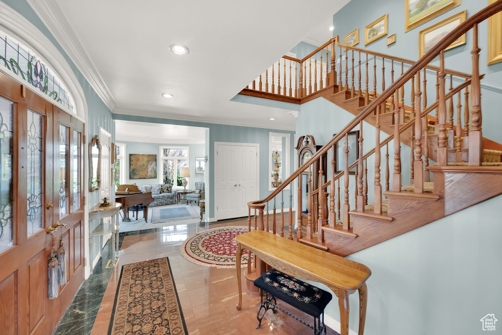 Entrance foyer featuring crown molding, french doors, stairs, and recessed lighting