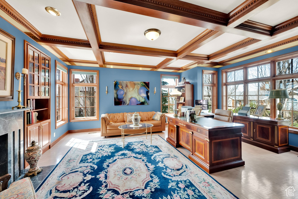 Office with beam ceiling, coffered ceiling, and a premium fireplace