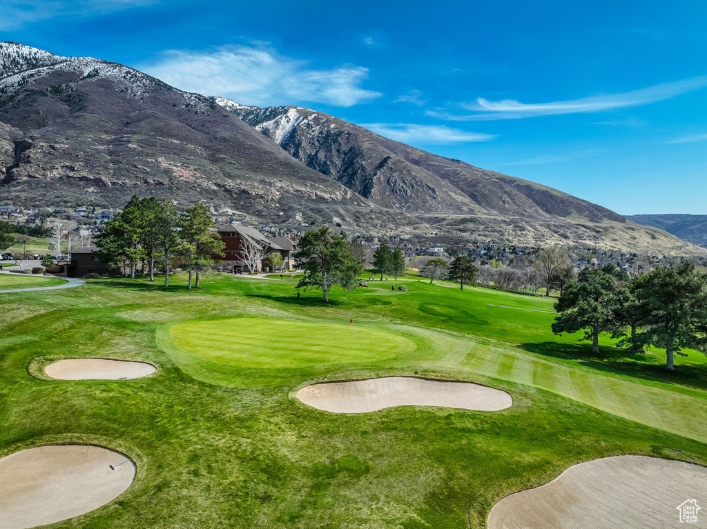 Surrounding community with a mountain view, golf course view, and a yard