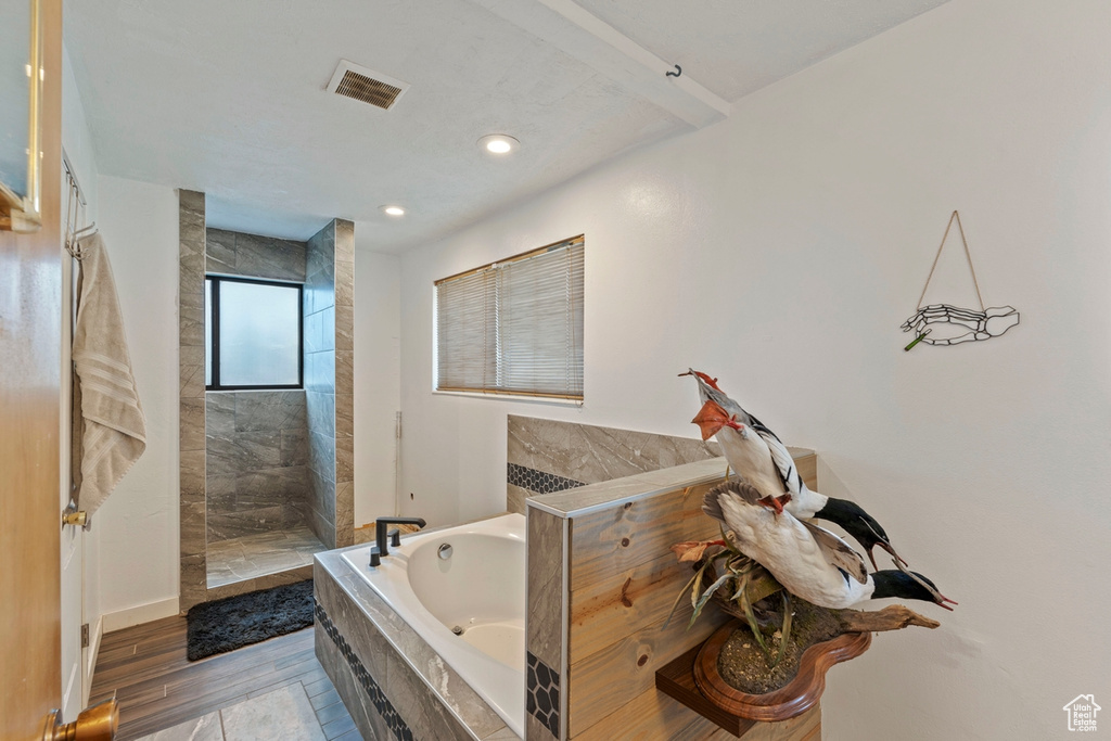 Bathroom with a bath, walk in shower, and recessed lighting