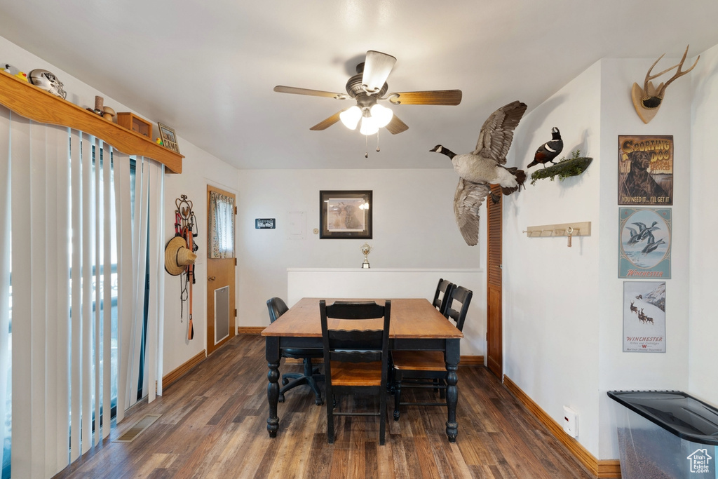 Dining space featuring wood finished floors and ceiling fan