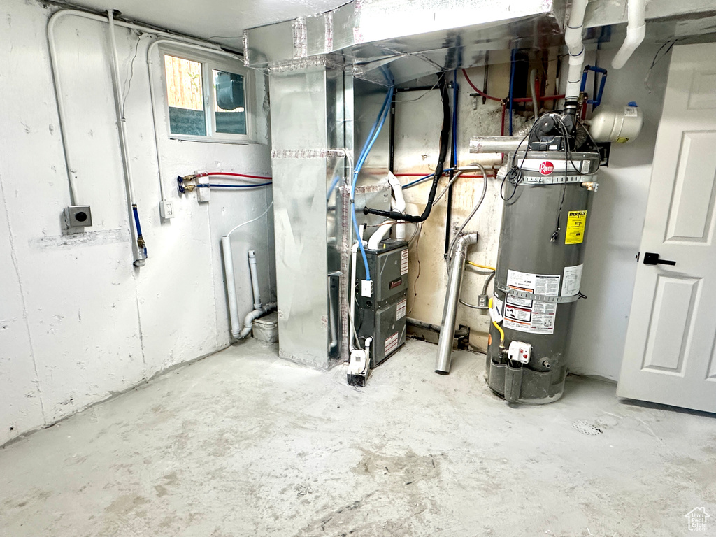 Utility room with gas water heater and heating unit