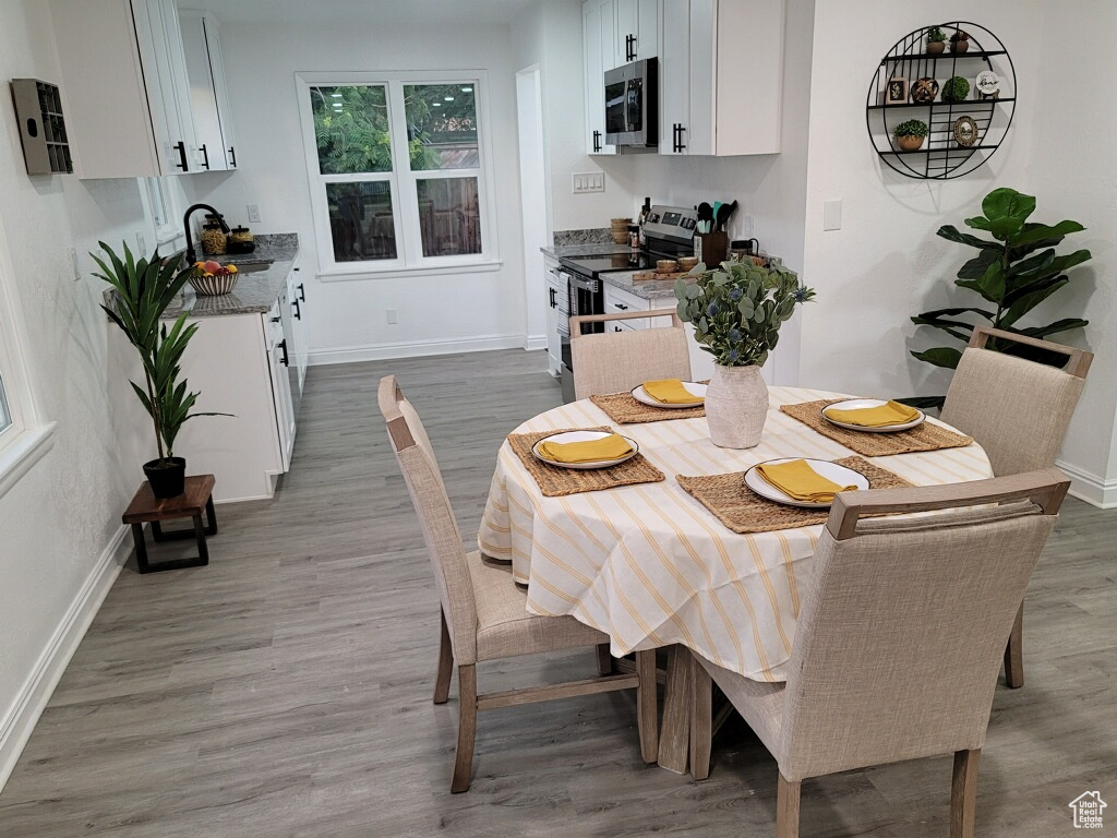 Dining space with wood finished floors and baseboards