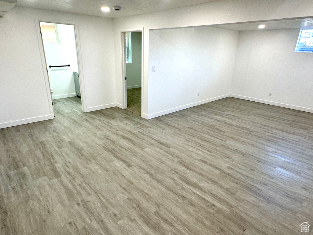 Unfurnished room with wood finished floors, recessed lighting, and a smoke detector