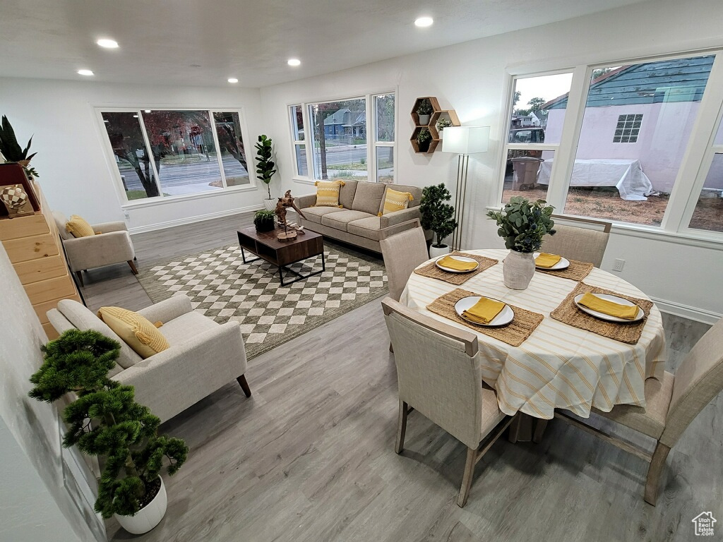 Dining area featuring wood finished floors, healthy amount of natural light, and recessed lighting
