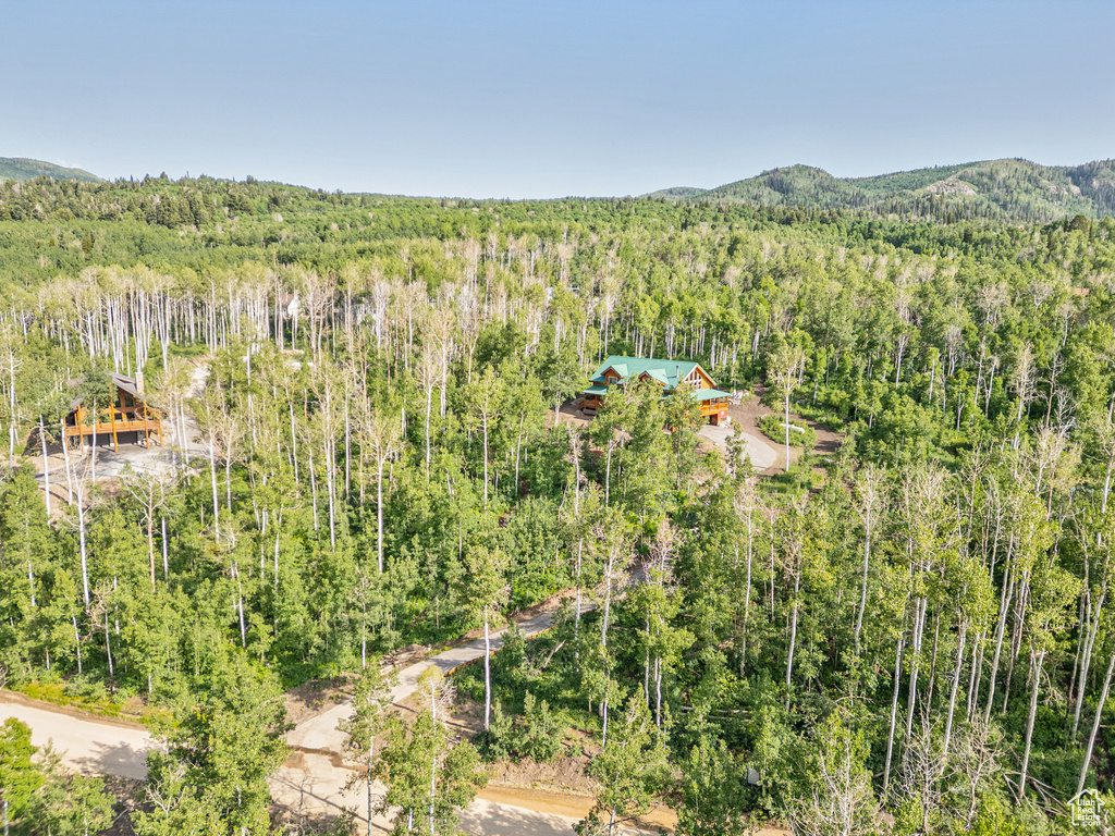 View of subject property featuring a heavily wooded area