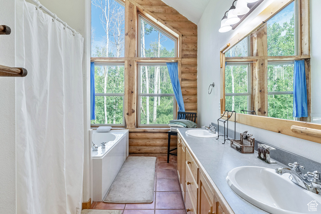Bathroom featuring rustic walls, double vanity, a garden tub, tile patterned flooring, and high vaulted ceiling
