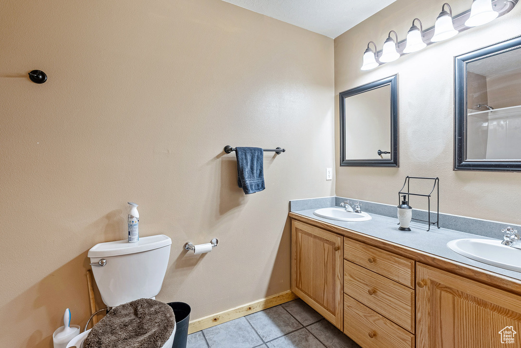 Bathroom with tile patterned floors and double vanity