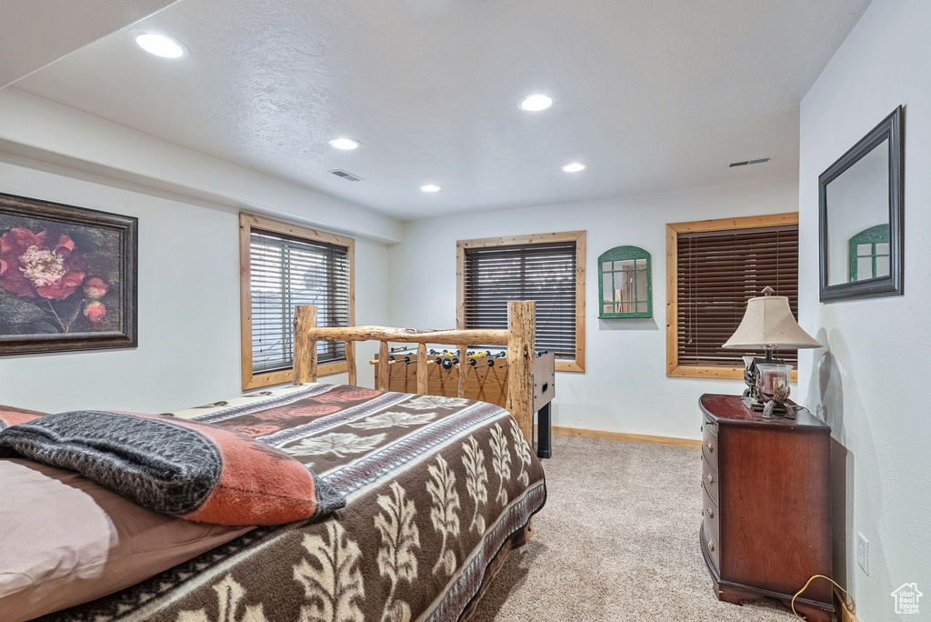 Bedroom featuring recessed lighting and light carpet