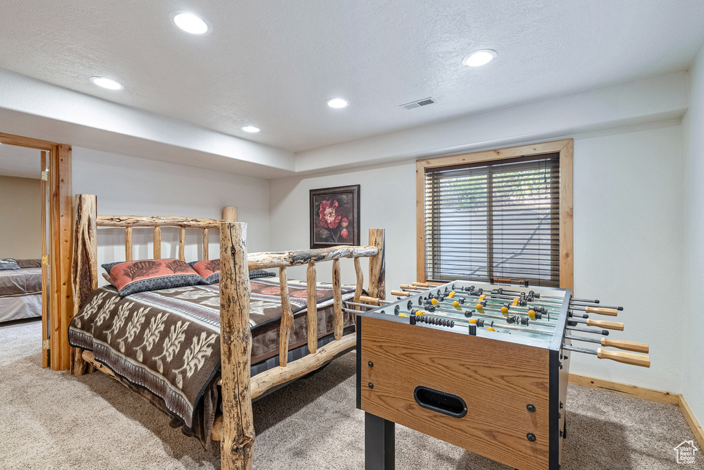 Carpeted bedroom with recessed lighting