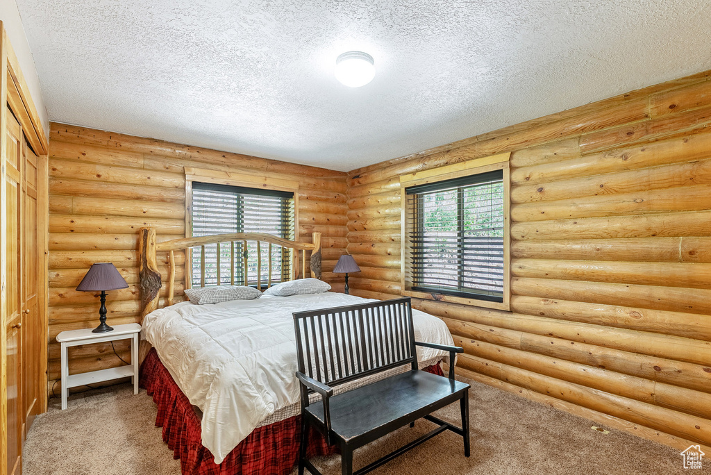 Carpeted bedroom featuring a textured ceiling