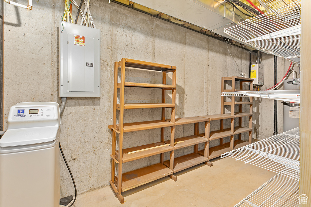 Unfinished basement featuring electric panel and a water softener system