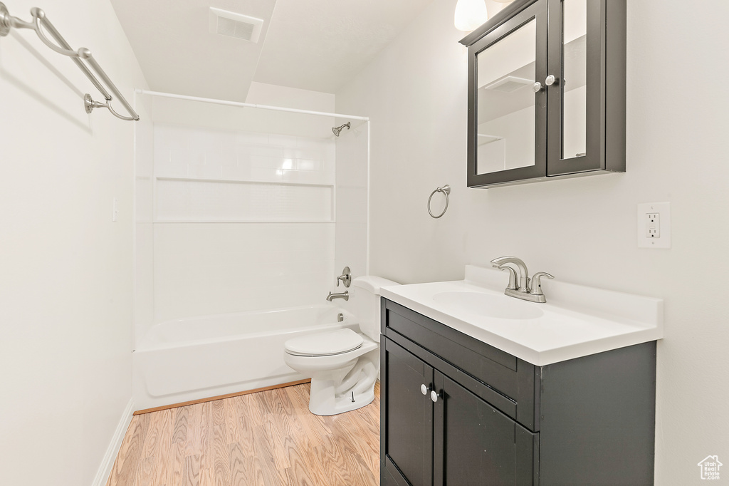 Full bathroom featuring vanity, bathing tub / shower combination, and wood finished floors