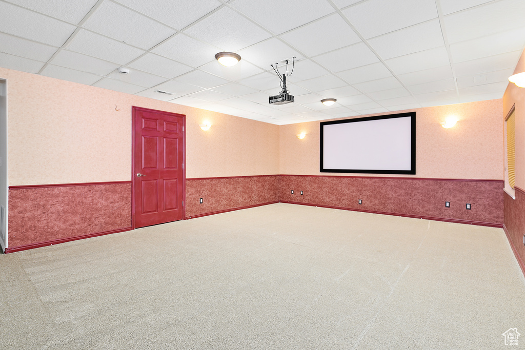 Cinema room with wainscoting, a drop ceiling, and carpet flooring