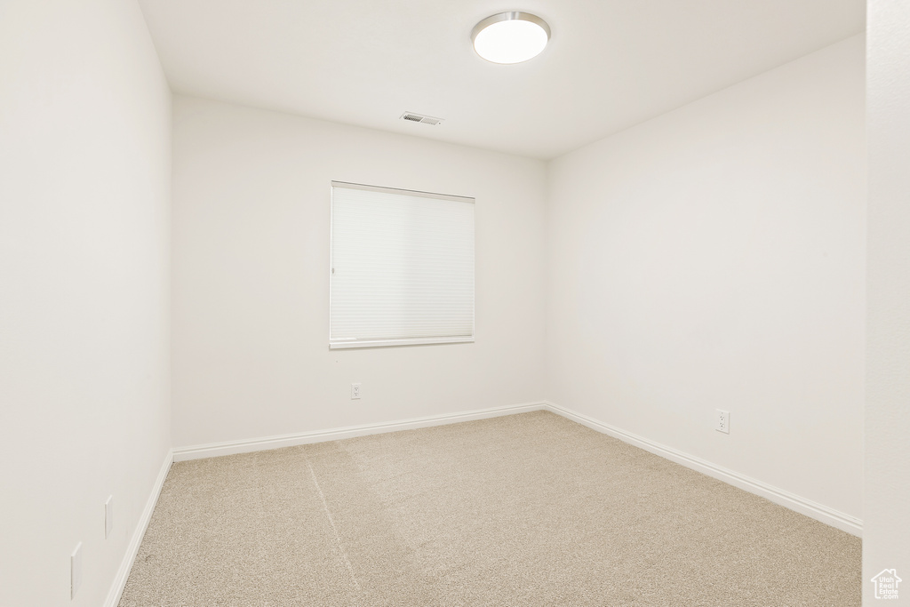 Empty room with carpet floors and baseboards