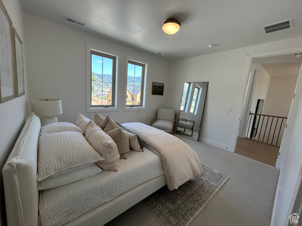 Bedroom featuring carpet and baseboards