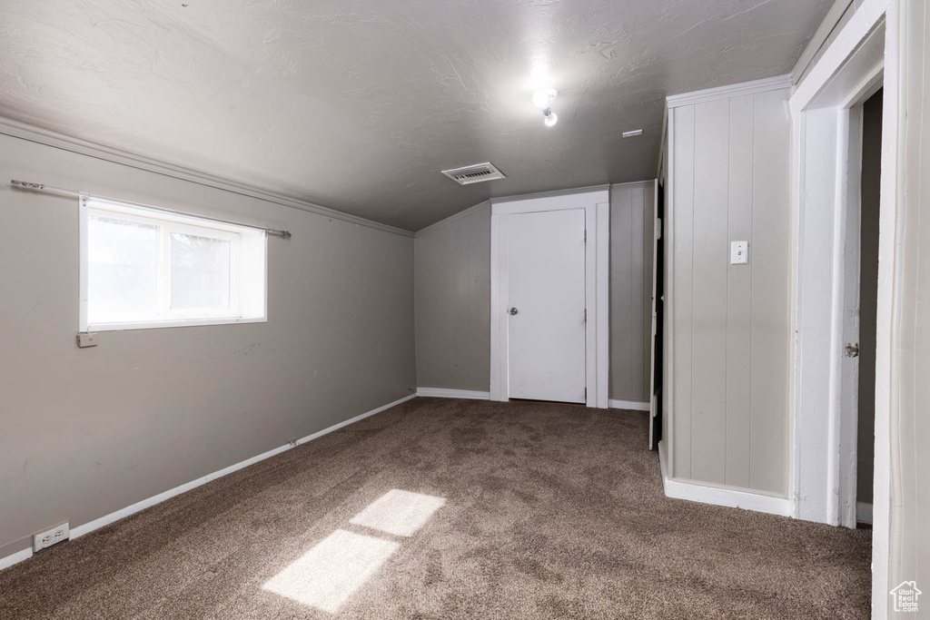 Bonus room featuring carpet flooring and lofted ceiling