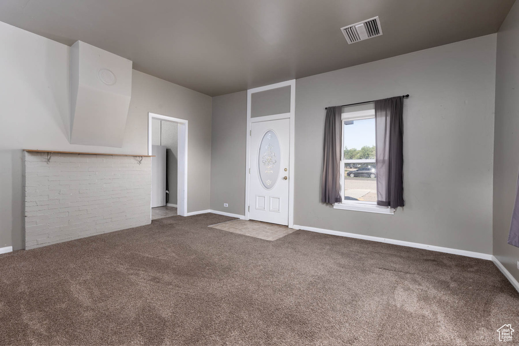 Carpeted entrance foyer with baseboards
