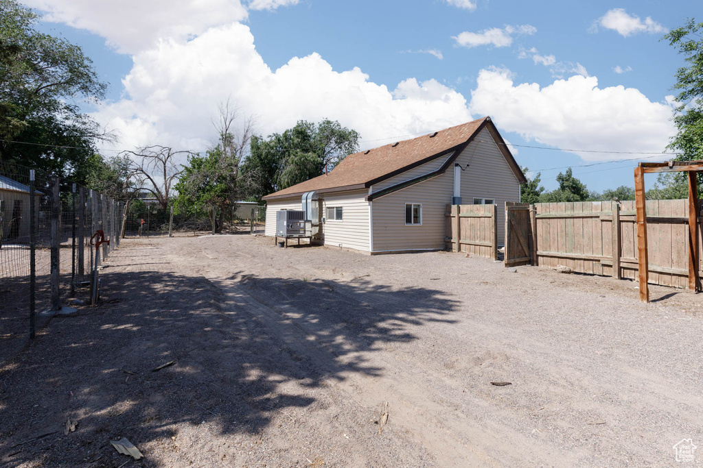 View of property exterior with a gate