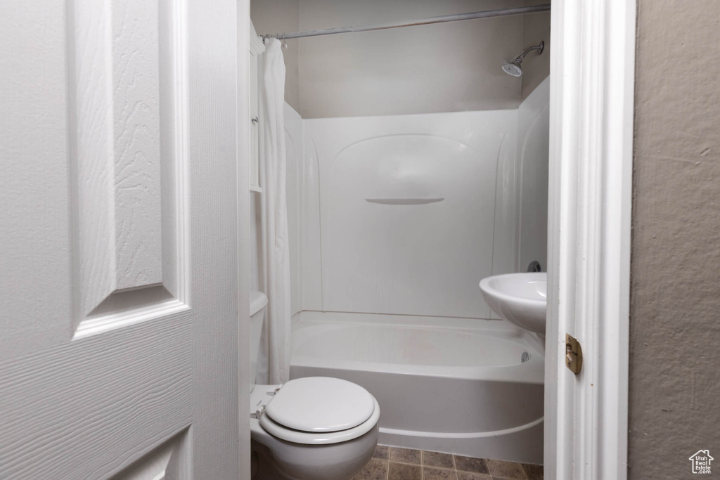 Bathroom featuring shower / bath combo with shower curtain and toilet