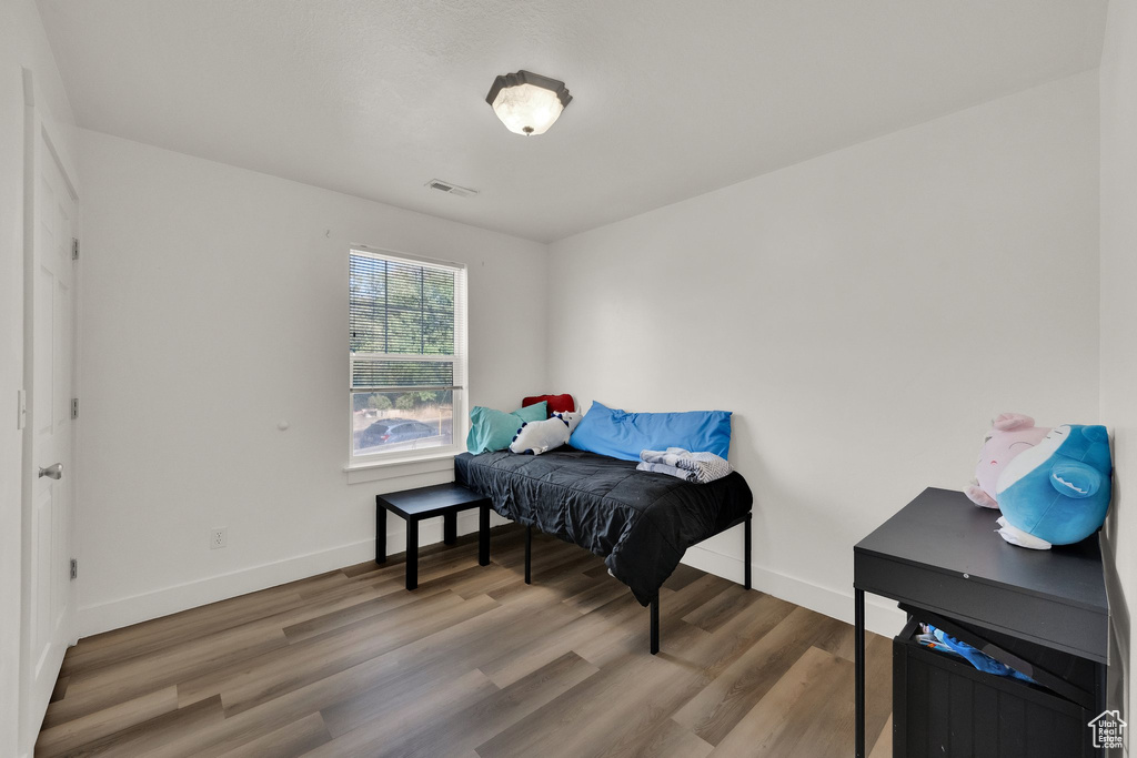 Sitting room featuring baseboards and wood finished floors