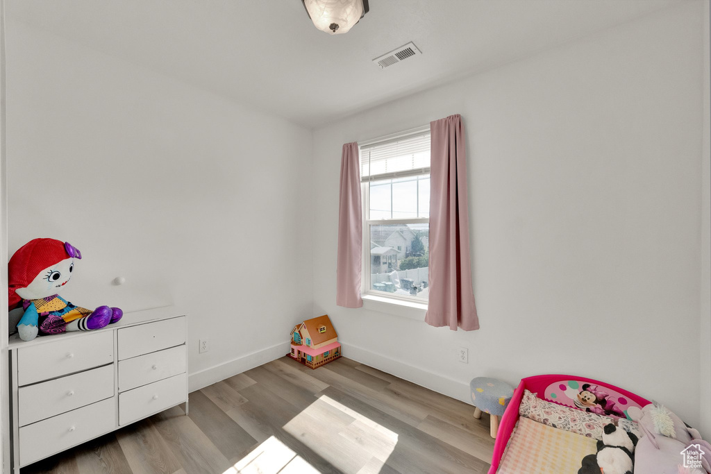 Playroom with wood finished floors and baseboards