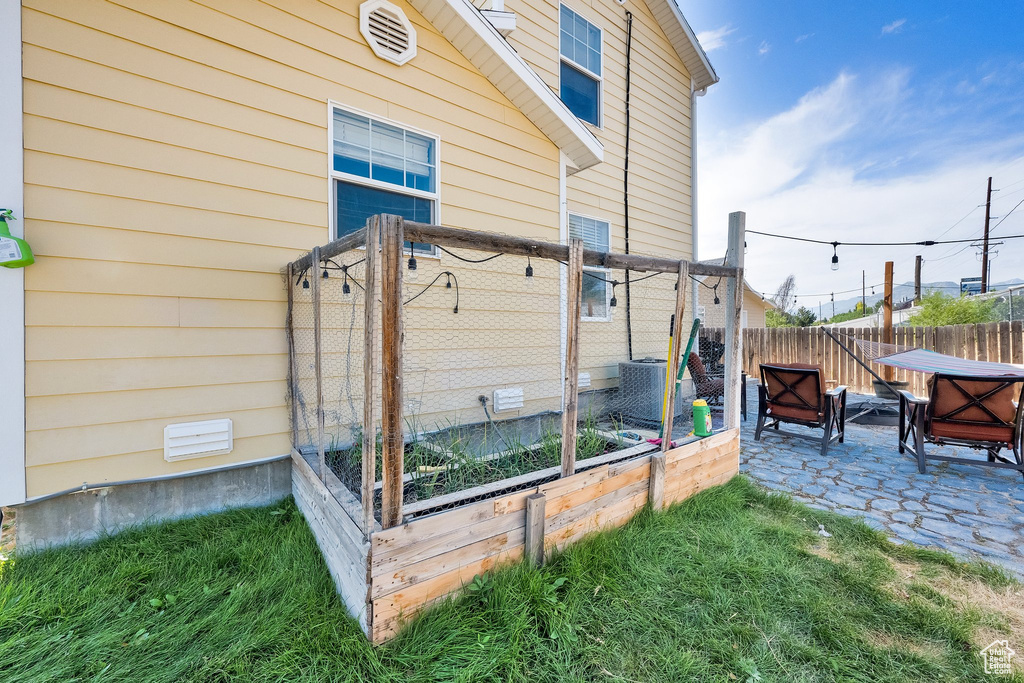 Exterior space featuring a patio area and a cooling unit