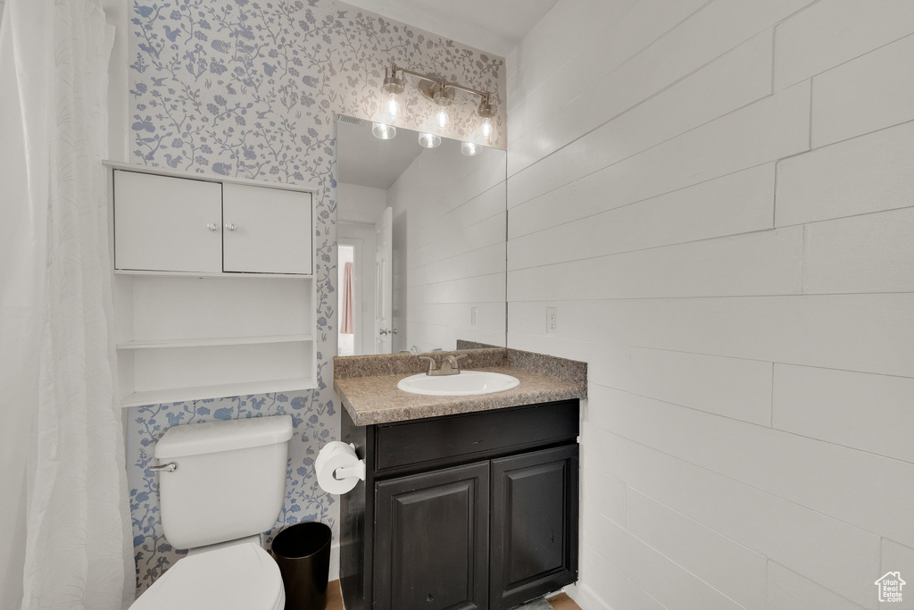 Bathroom featuring vanity and wallpapered walls