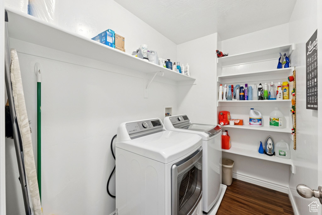 Laundry area with independent washer and dryer and wood finished floors
