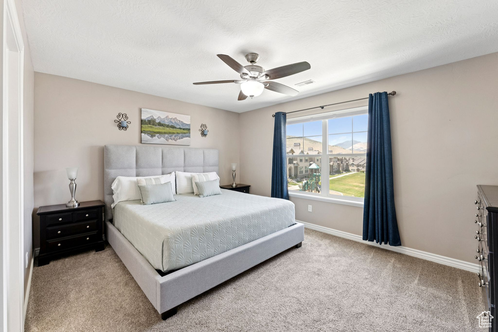 Bedroom featuring carpet and a ceiling fan