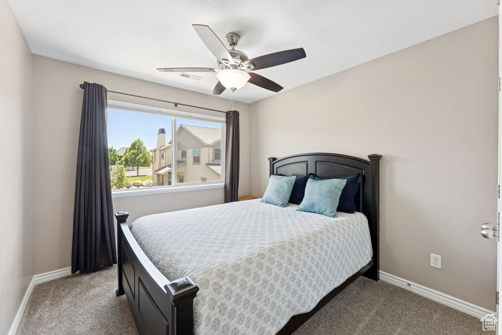 Bedroom with carpet floors and a ceiling fan