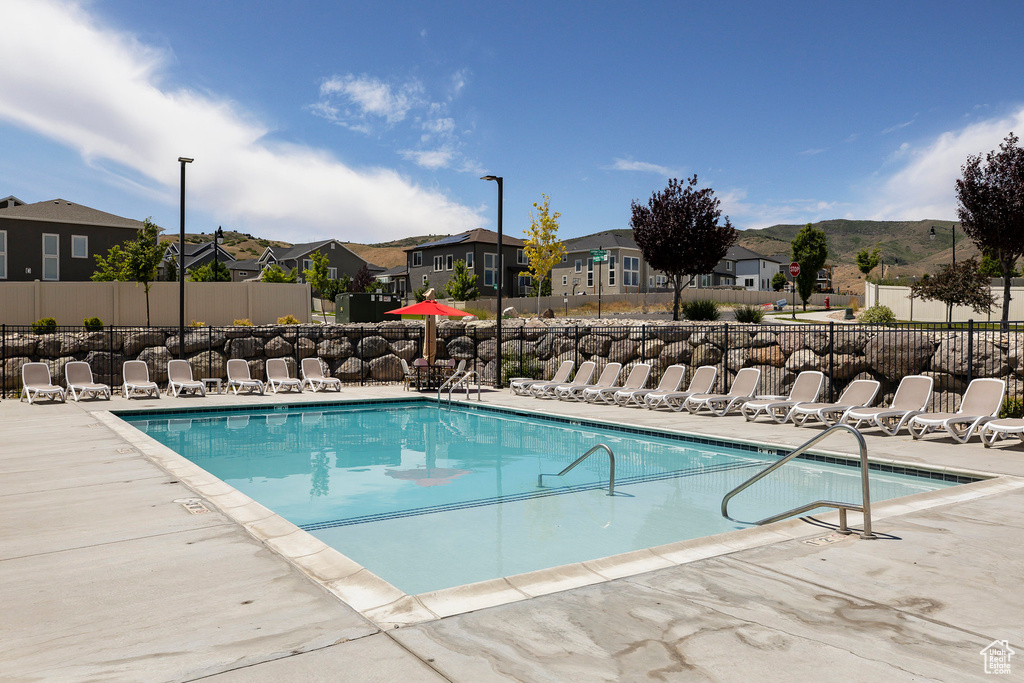 Community pool with a residential view and a patio area