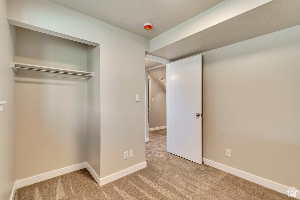 Unfurnished bedroom with carpet floors and baseboards