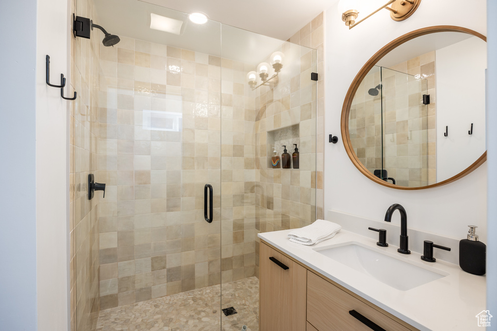 Bathroom with vanity and a stall shower