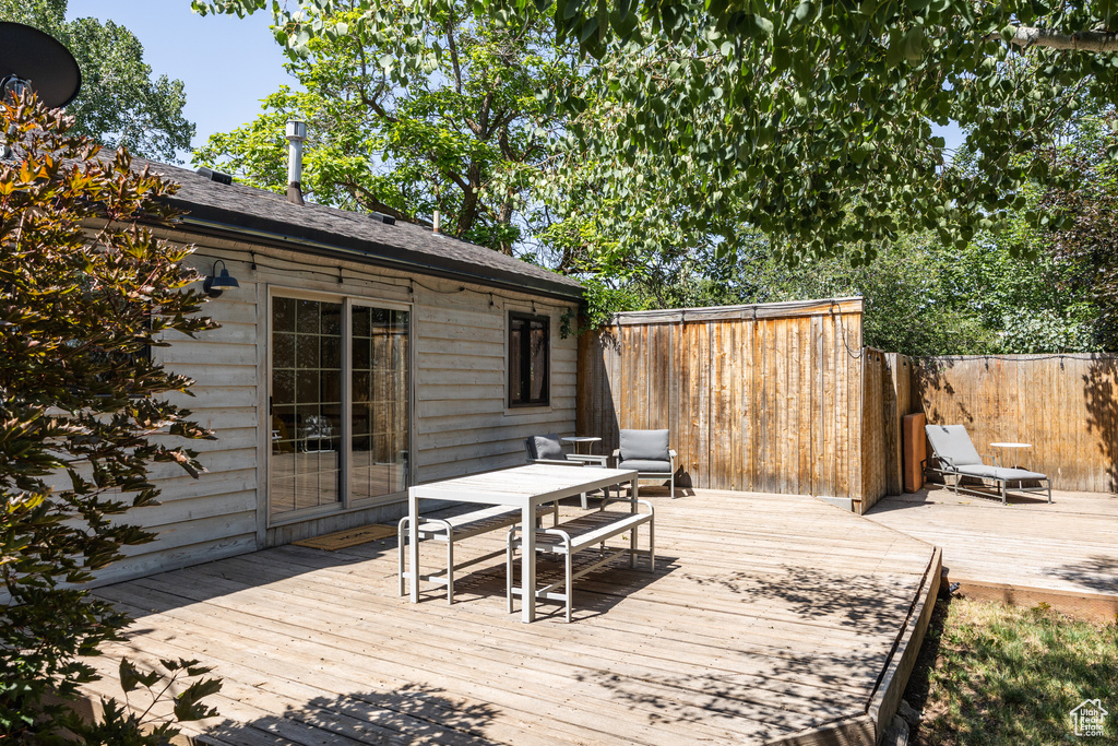 Wooden deck featuring outdoor dining area