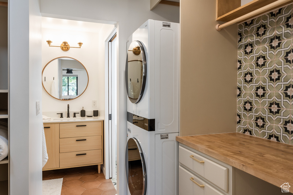 Laundry area featuring estacked washer and dryer and tile patterned floors
