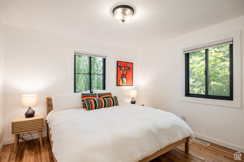Bedroom featuring wood finished floors and baseboards