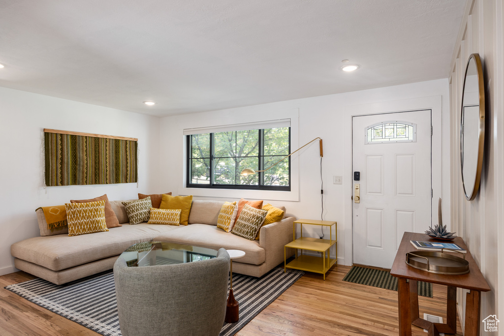 Living room featuring plenty of natural light, light wood finished floors, and recessed lighting