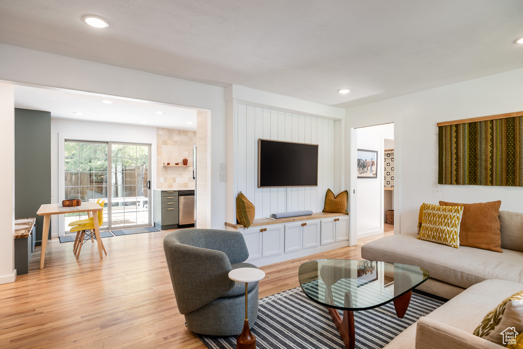 Living area with light wood-style flooring and recessed lighting