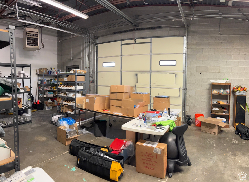 Garage featuring concrete block wall