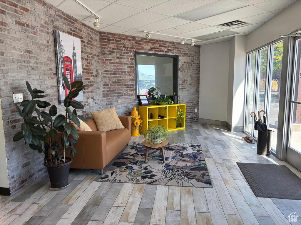 Building lobby with brick wall and a paneled ceiling