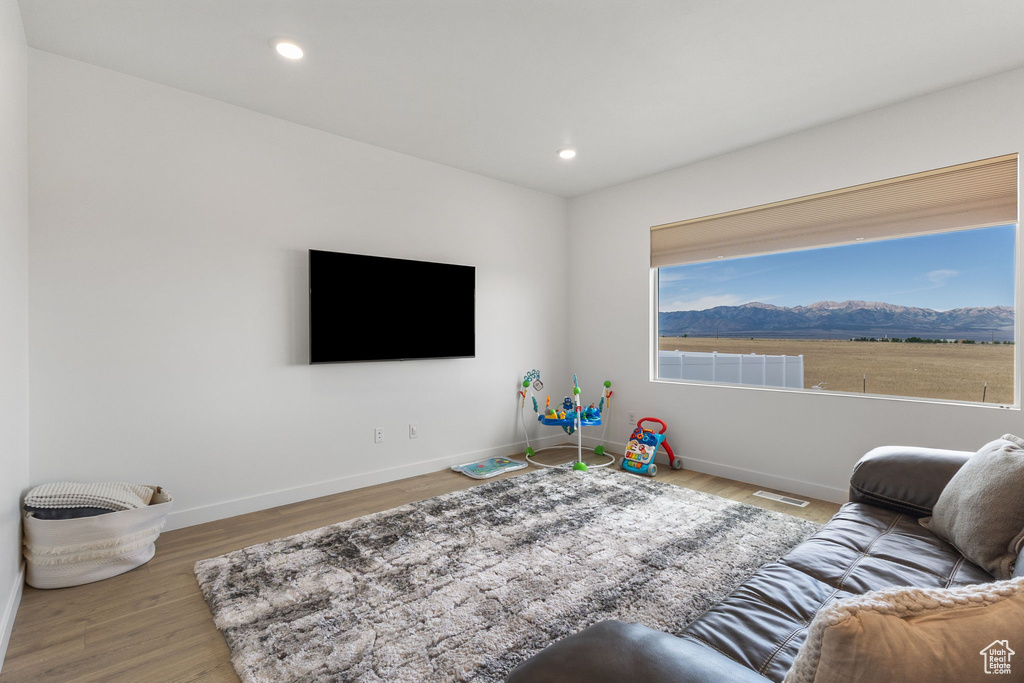 Living room featuring wood finished floors and recessed lighting