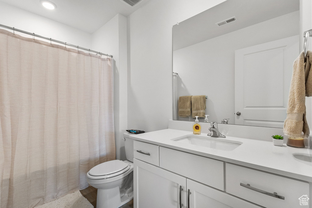 Full bathroom with vanity and recessed lighting