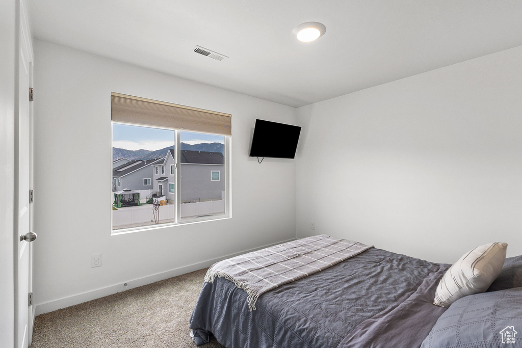 Carpeted bedroom featuring baseboards