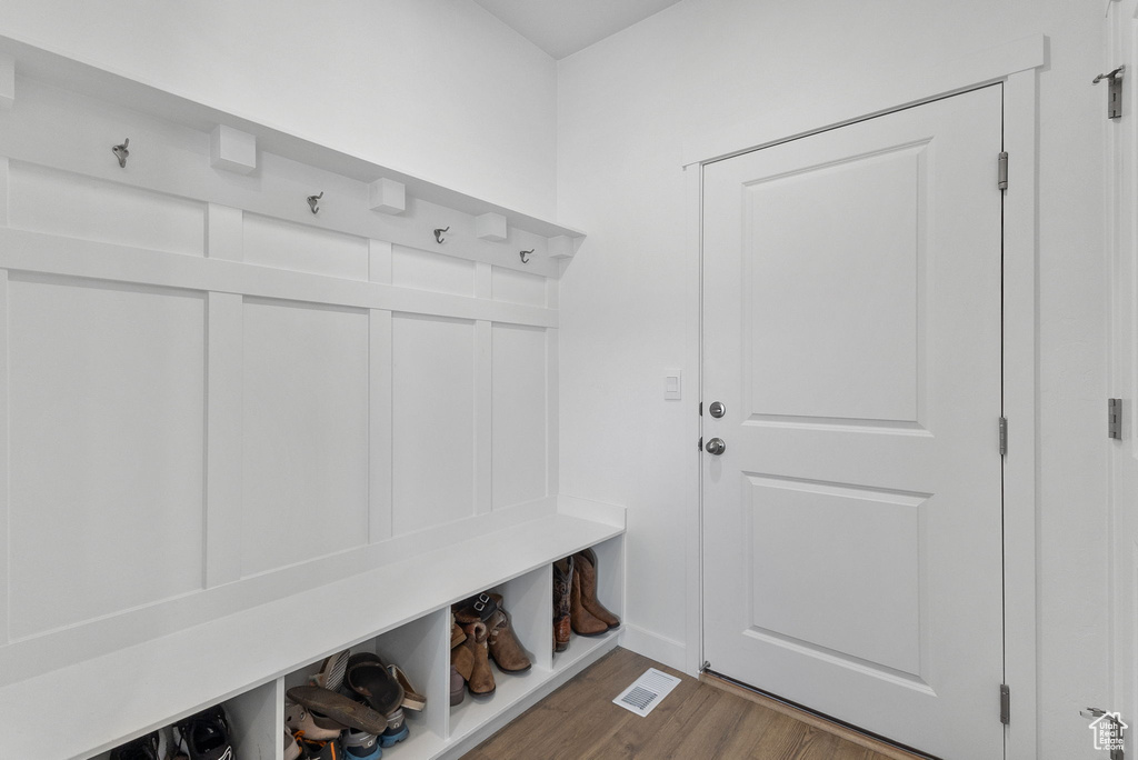 Mudroom with wood finished floors and baseboards